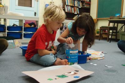 Two children choose cutout figures